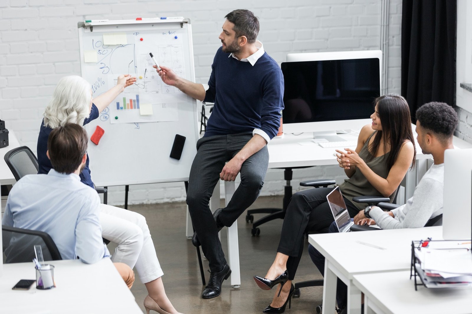 About us, creative people sitting at table in boardroom